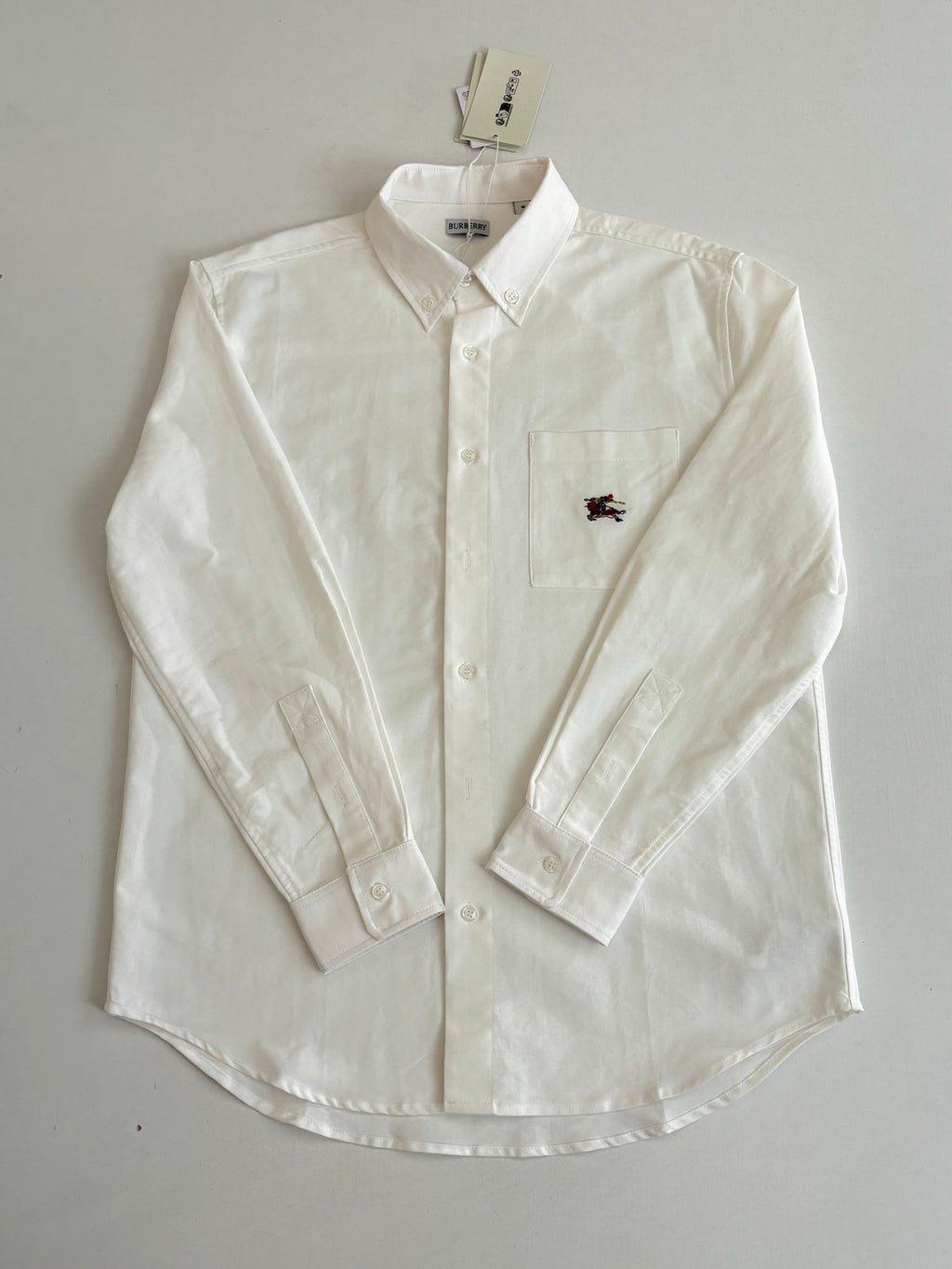 White Burberry long-sleeve button shirt with chest pocket and horse logo