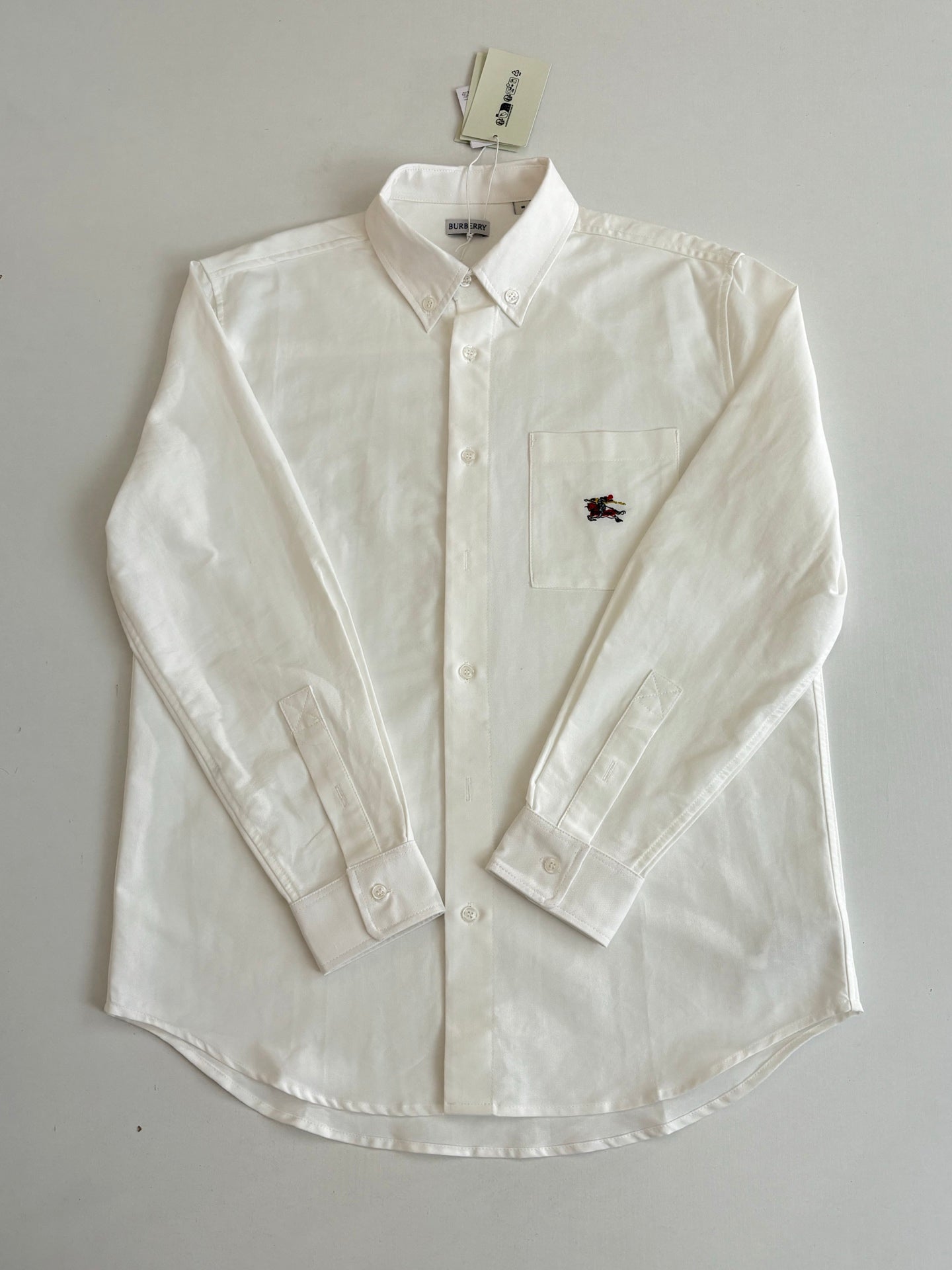 White Burberry long-sleeve button shirt with chest pocket and horse logo
