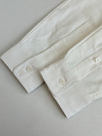 White long-sleeve shirt cuff with two buttons and buttonholes