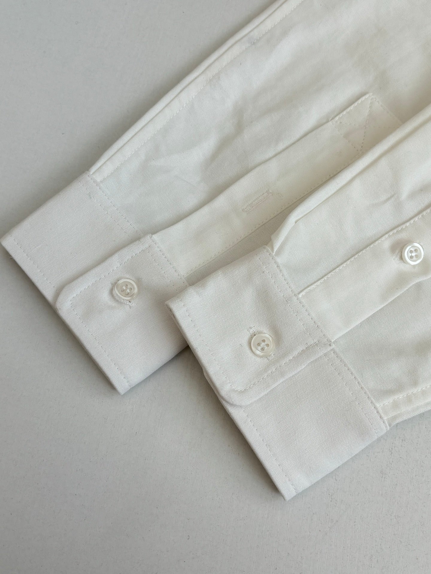 White long-sleeve shirt cuff with two buttons and buttonholes