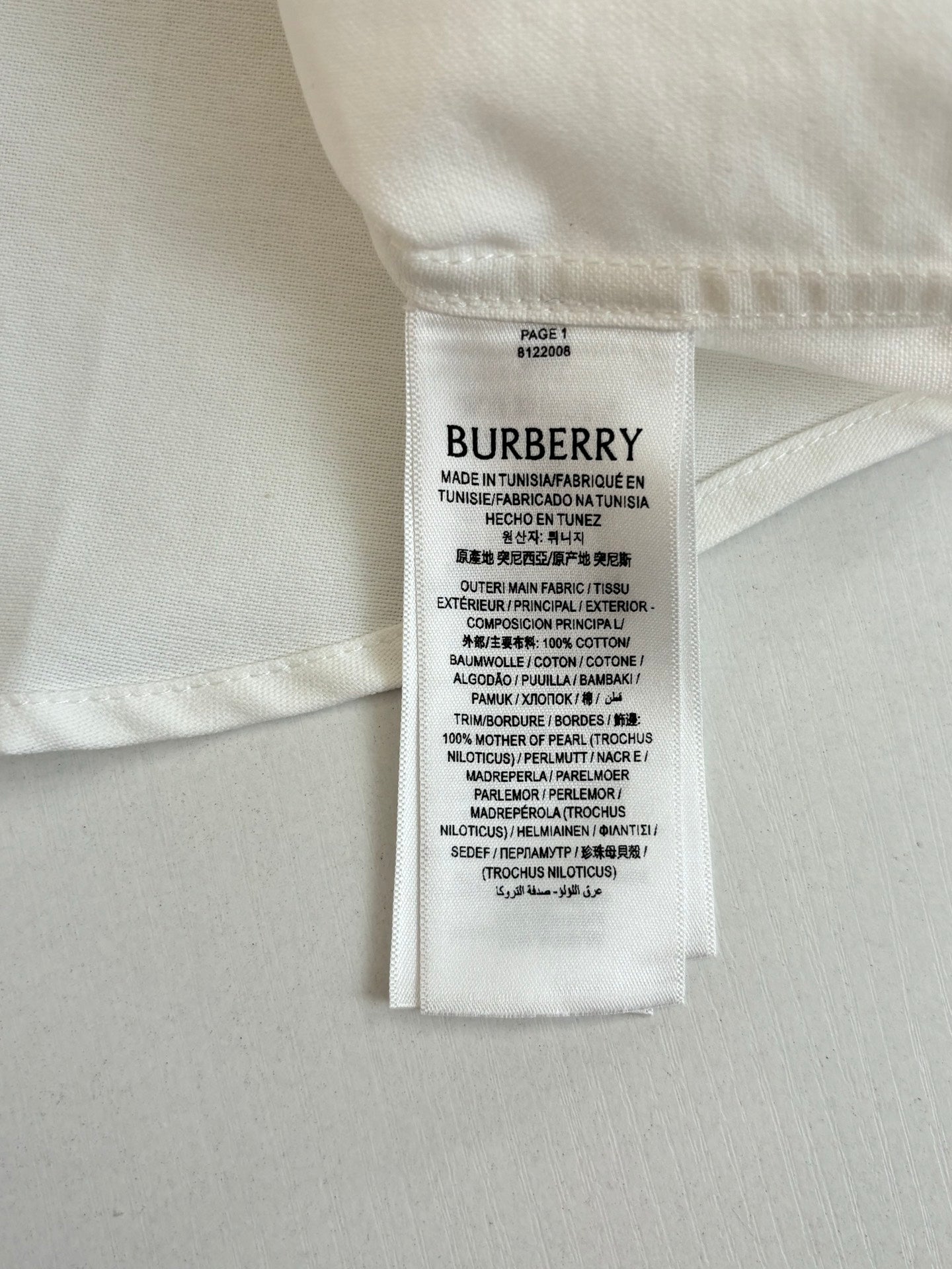Burberry size and care label on a white long-sleeve shirt