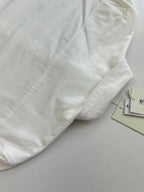 White long-sleeve shirt with stitched panel detail on the front