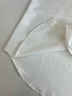 White long-sleeve shirt cuff with stitched seam and folded edge