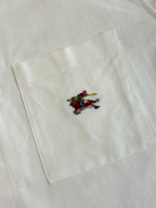 White shirt fabric with embroidered horse logo near the chest