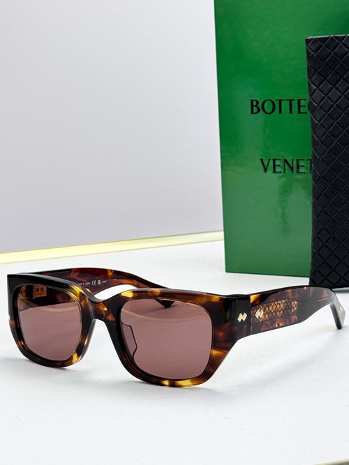 Bottega Veneta sunglasses with tortoise frames, brown lenses, and gold patterned temples