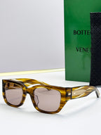 Bottega Veneta sunglasses with amber tortoise frames, gray lenses, and gold patterned temples