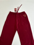 Burgundy pants with elastic waistband and embroidered side crest logo