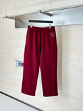 Burgundy pants with elastic waistband and small side logo detail