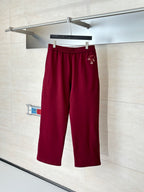 Burgundy pants with elastic waistband and small side logo detail