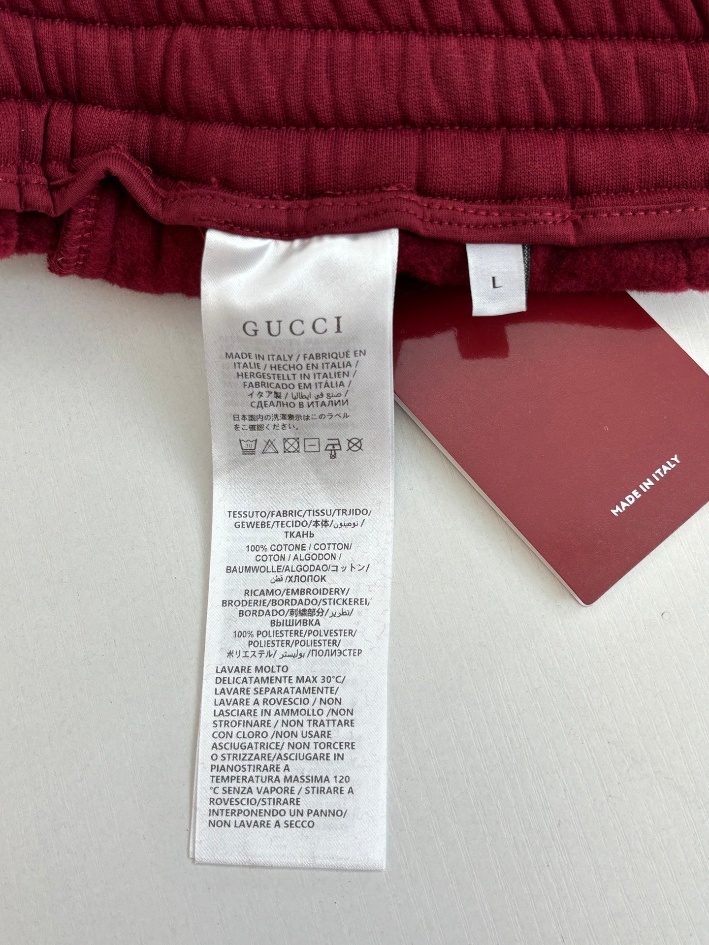Gucci pants fabric care label and size tag inside waistband