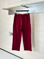 Burgundy pants with elastic waistband and clean straight-leg silhouette