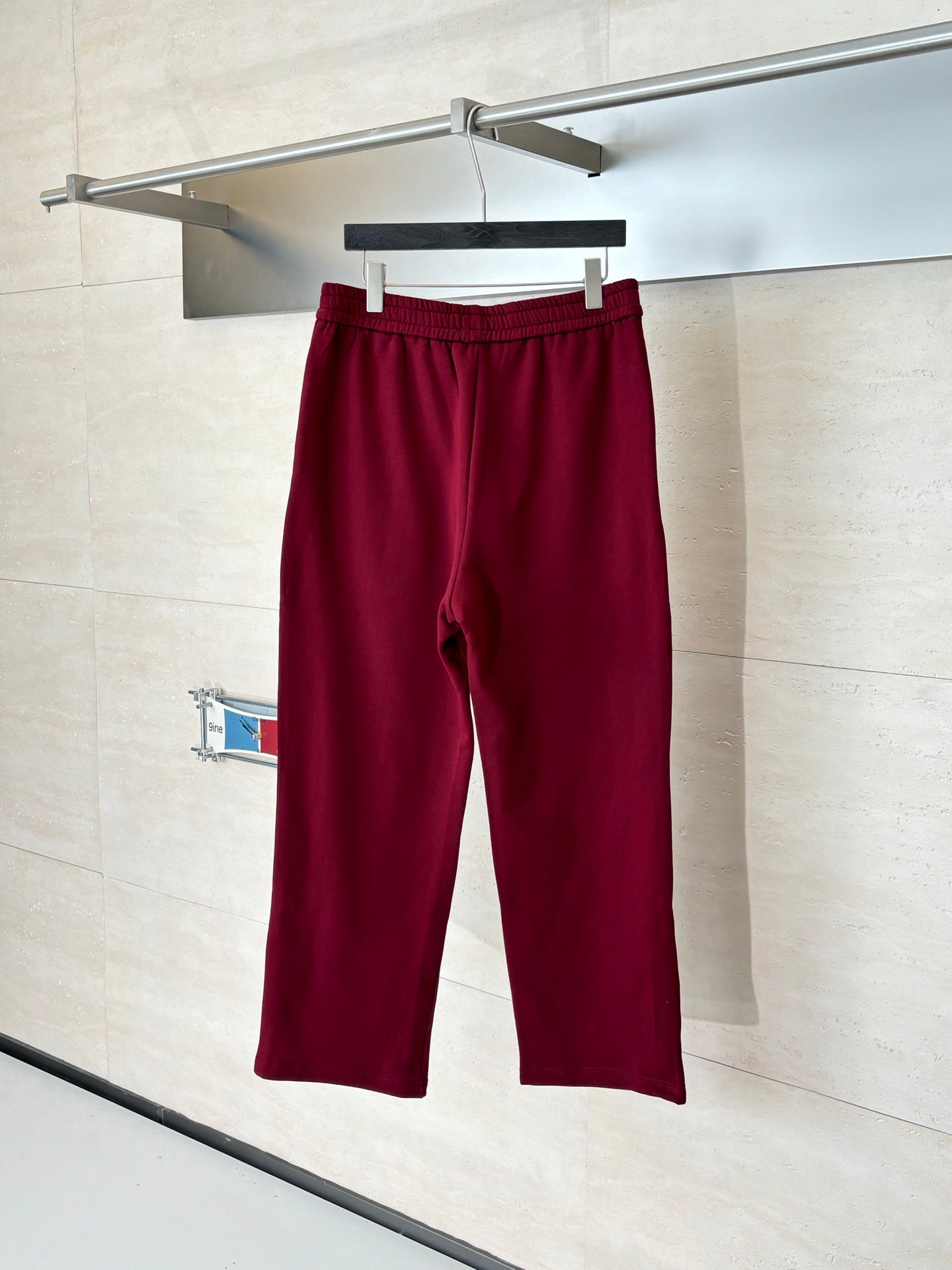 Burgundy pants with elastic waistband and clean straight-leg silhouette