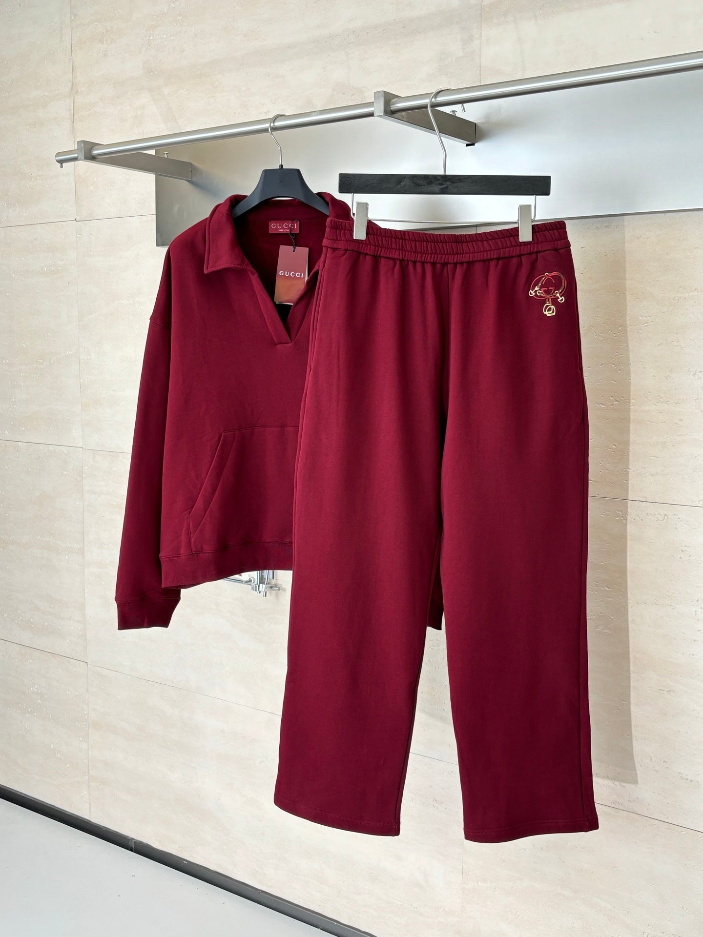 Burgundy pants with elastic waistband and side crest logo embroidery