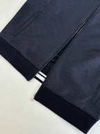 Navy Gucci track pants with front pocket and white striped waistband