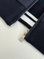 Navy Gucci track jacket zipper pull with white striped knit trim