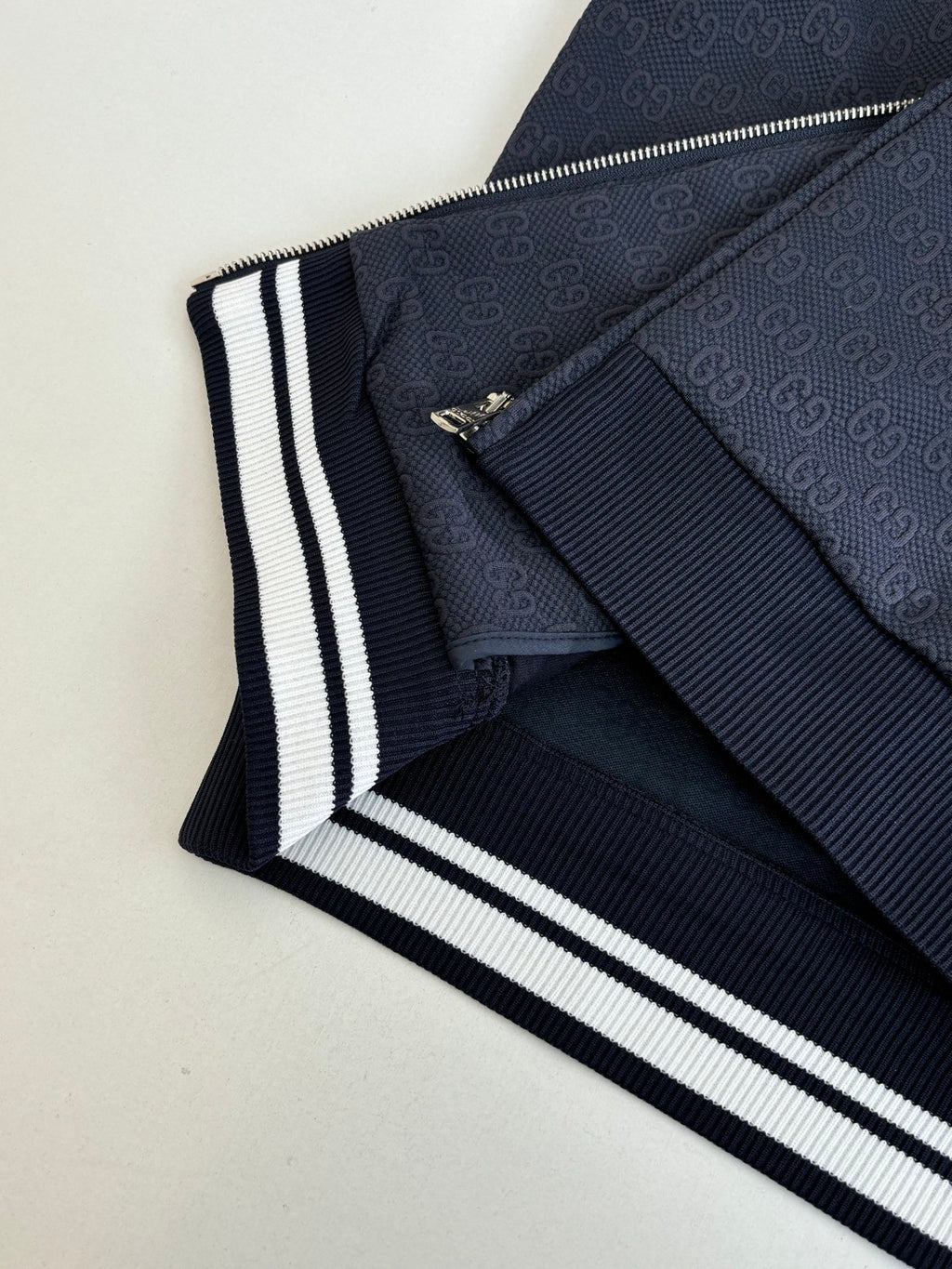 Navy Gucci jacket collar and sleeve cuff with white striped knit trim