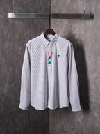 Striped button-up shirt in light blue and white with multicolor hanging tag