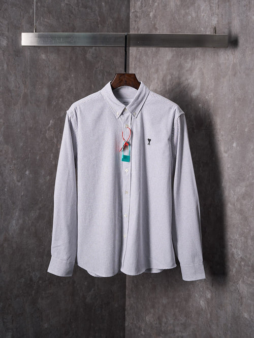 Striped button-up shirt in light blue and white with multicolor hanging tag