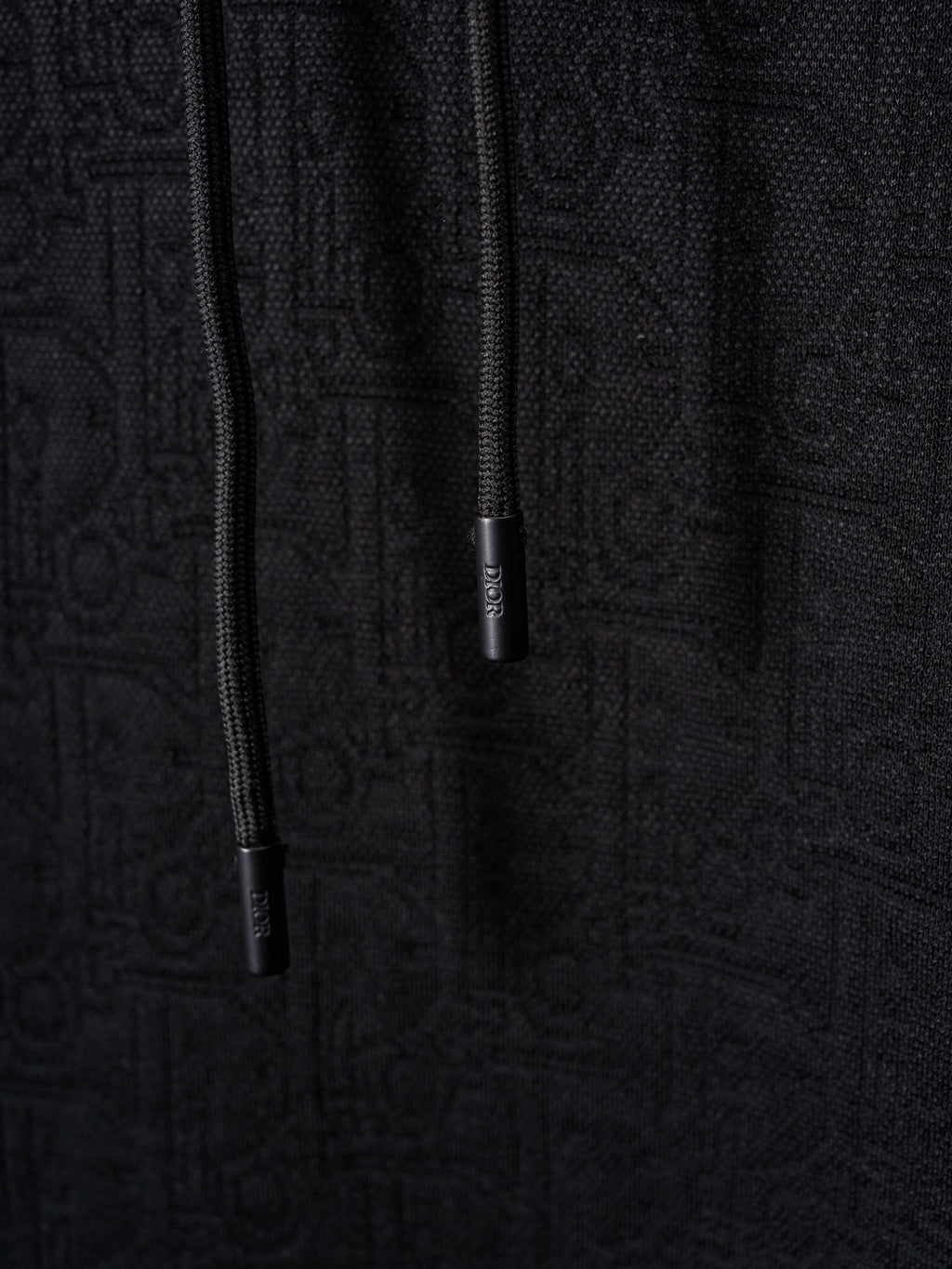 Black Dior zip-front hoodie with drawstrings and zipper pull