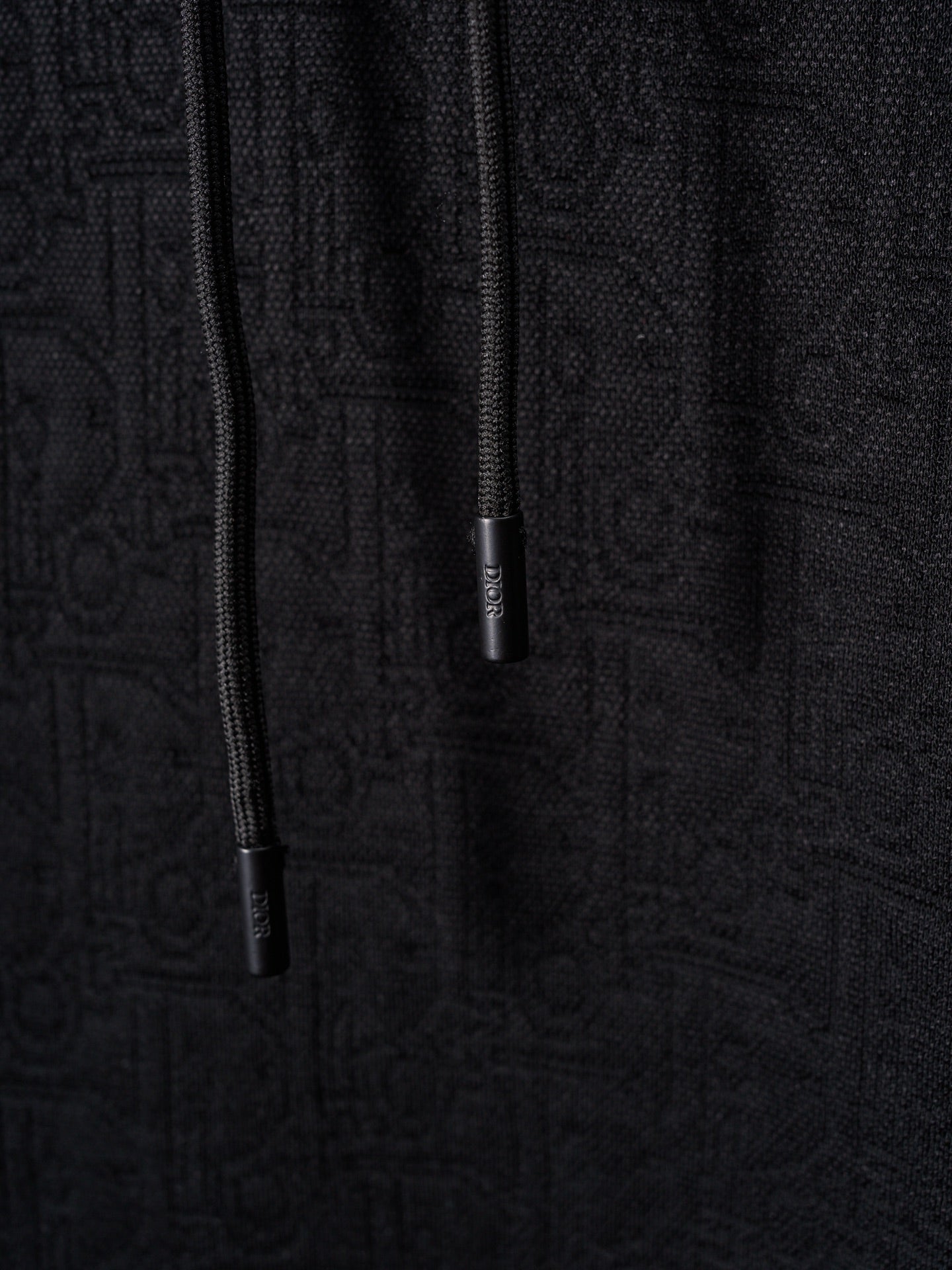 Black Dior zip-front hoodie with drawstrings and zipper pull