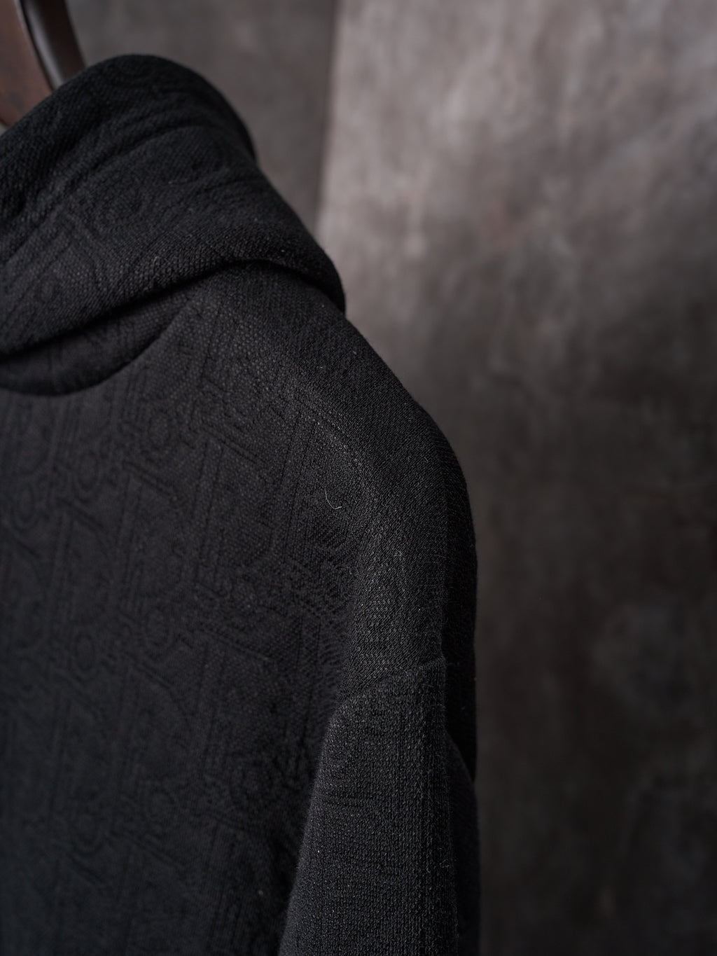 Black Dior hoodie sleeve with textured monogram pattern