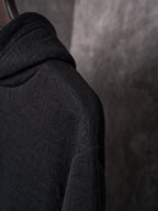 Black Dior hoodie sleeve with textured monogram pattern