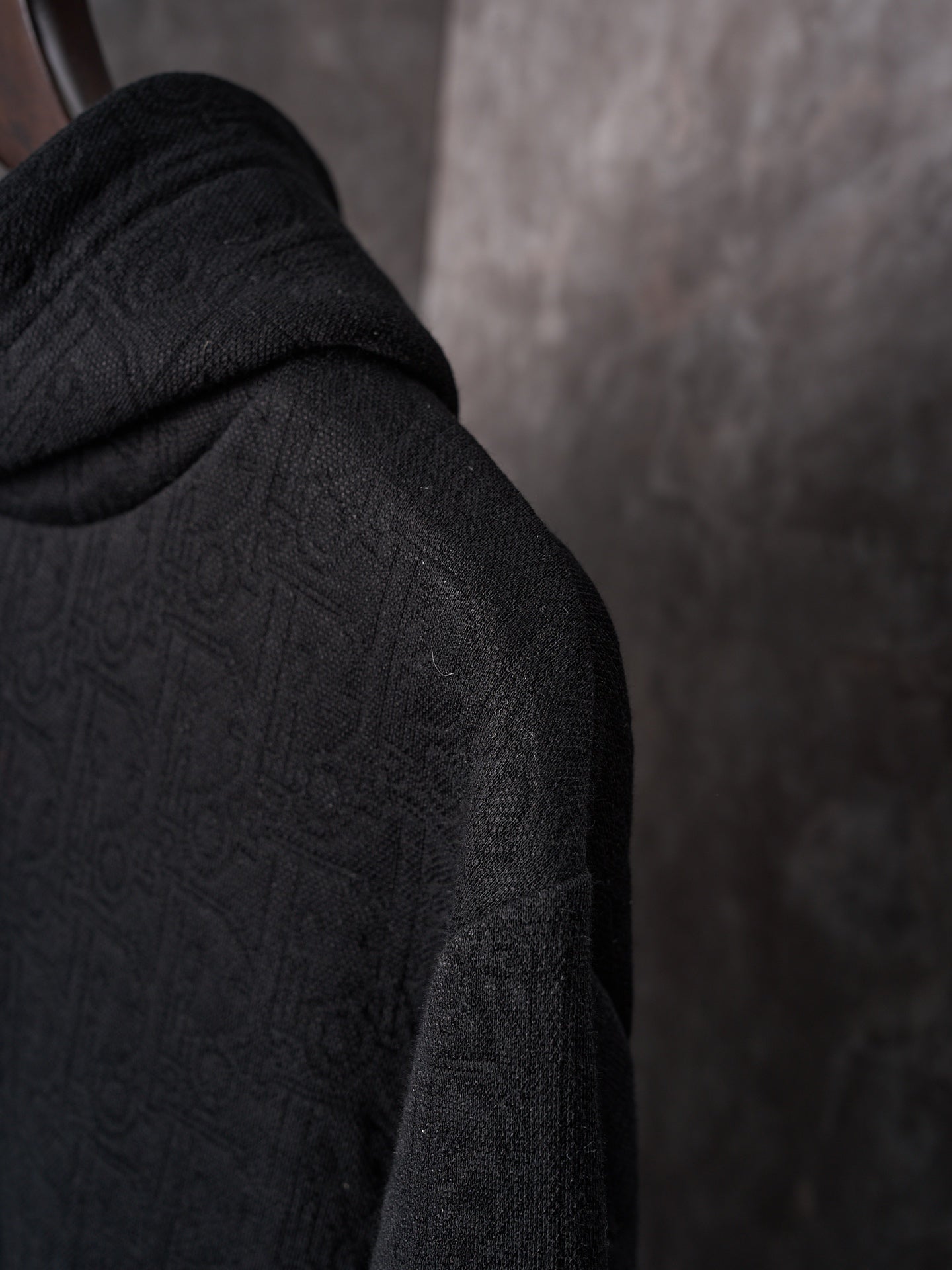 Black Dior hoodie sleeve with textured monogram pattern