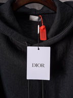 Black Dior zip-front hoodie hood with hanging DIOR tag