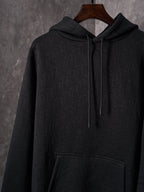 Black Dior zip-up hoodie with hood, drawstrings, and front pocket