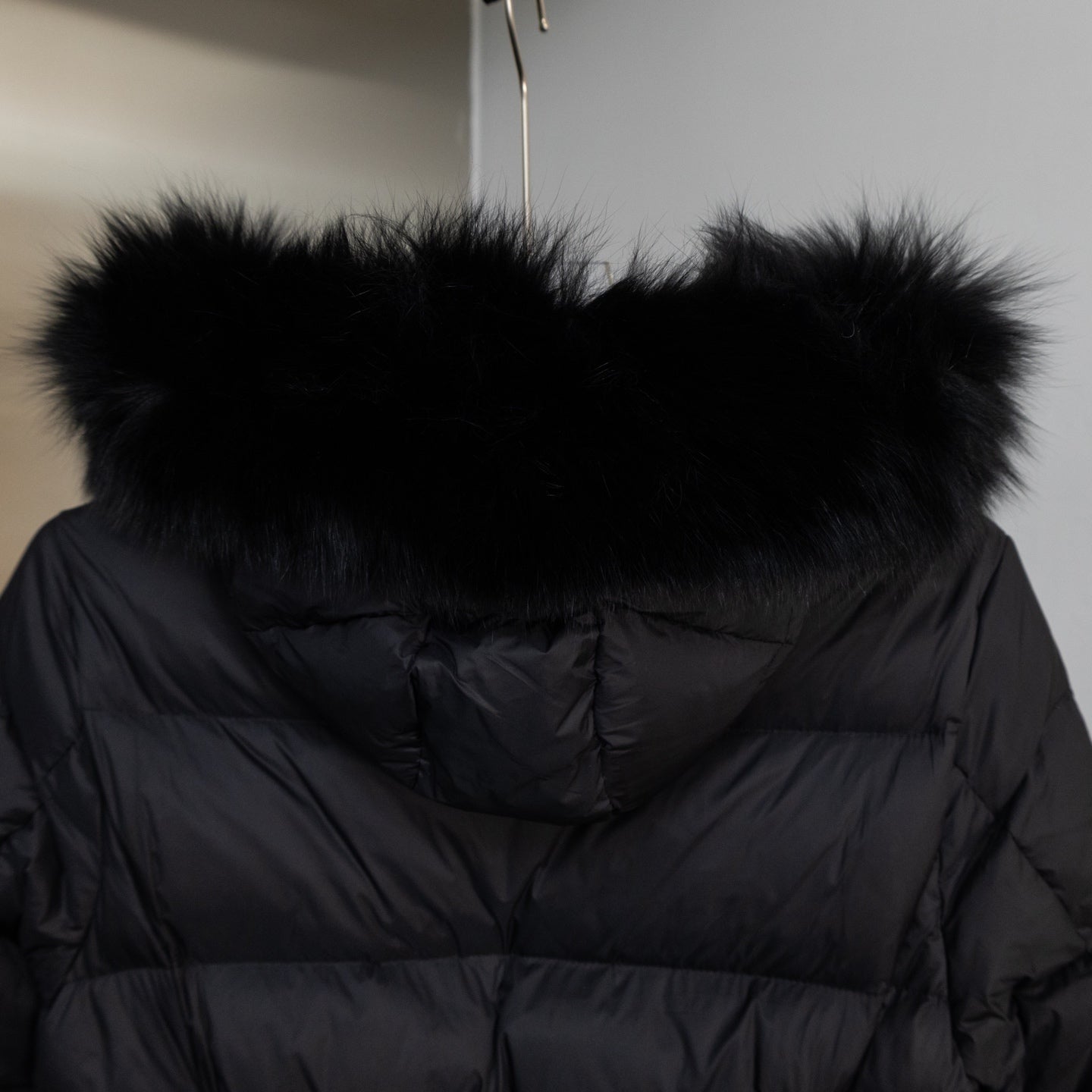 Moncler long puffer coat back view with hood faux fur trim, dark color