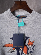 Light gray knit sweater with crew neck and multicolor graphic; brand tags visible
