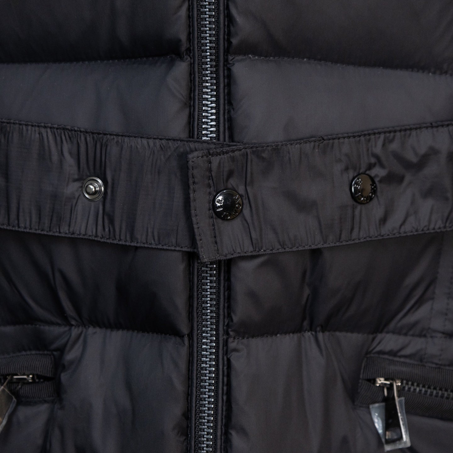 Moncler long puffer coat belt and front zipper detail, dark fabric