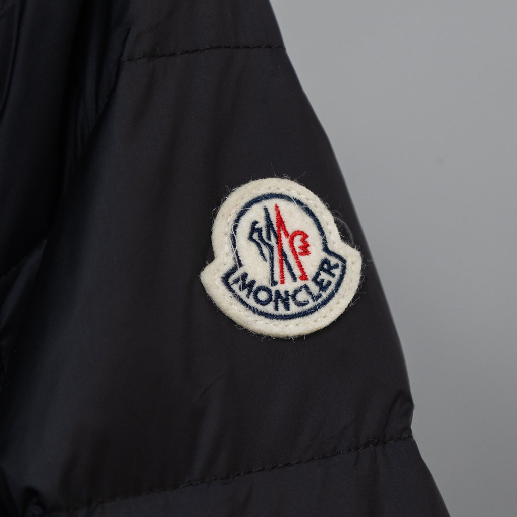 Moncler embroidered logo patch on long puffer coat sleeve, dark color