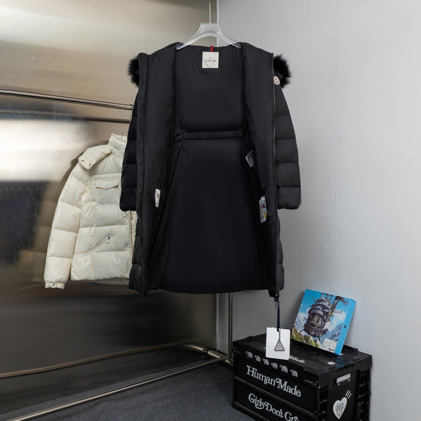 Moncler long puffer coat with faux fur hood and front zip, dark color