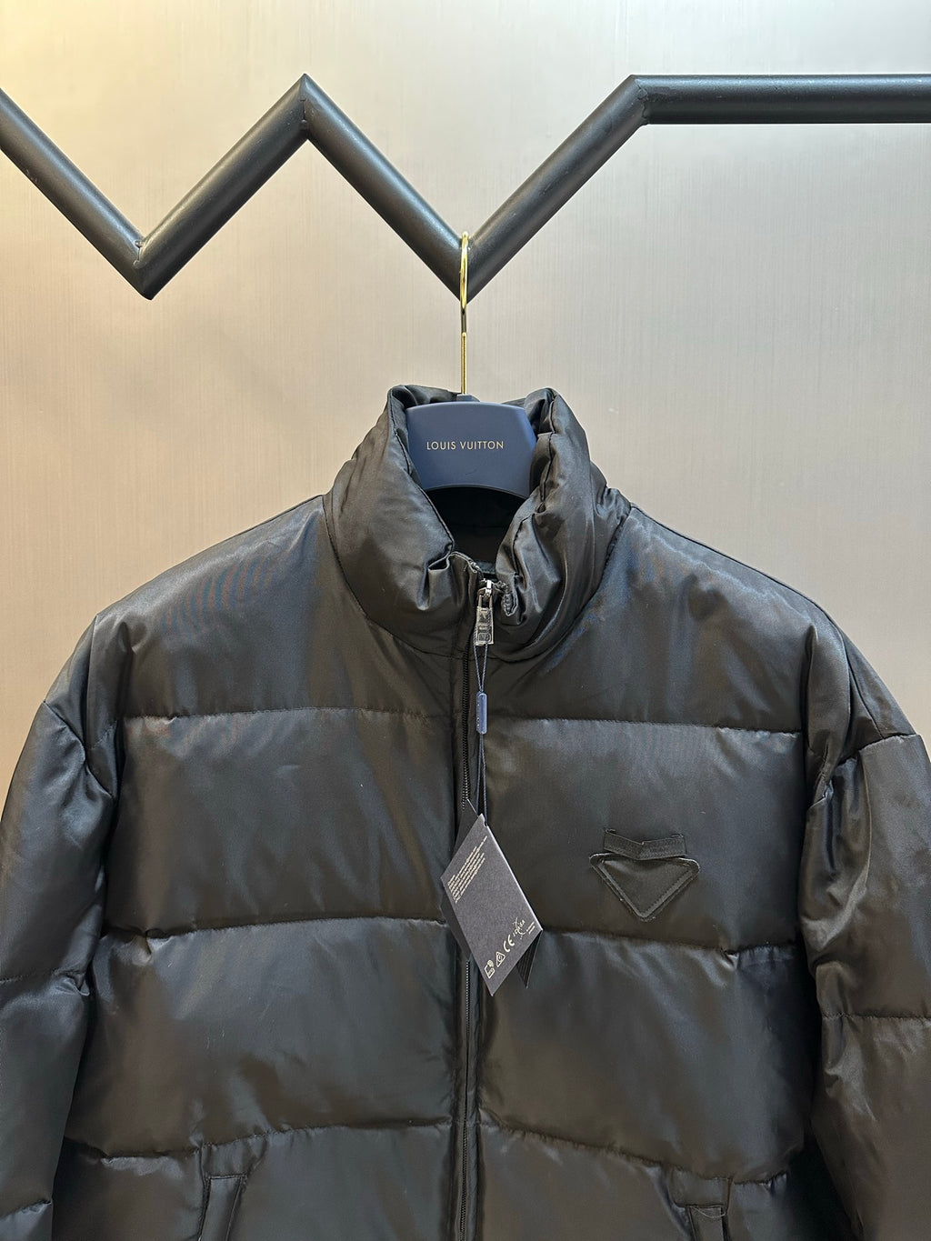 Prada dark puffer jacket front view with chest pocket and zip