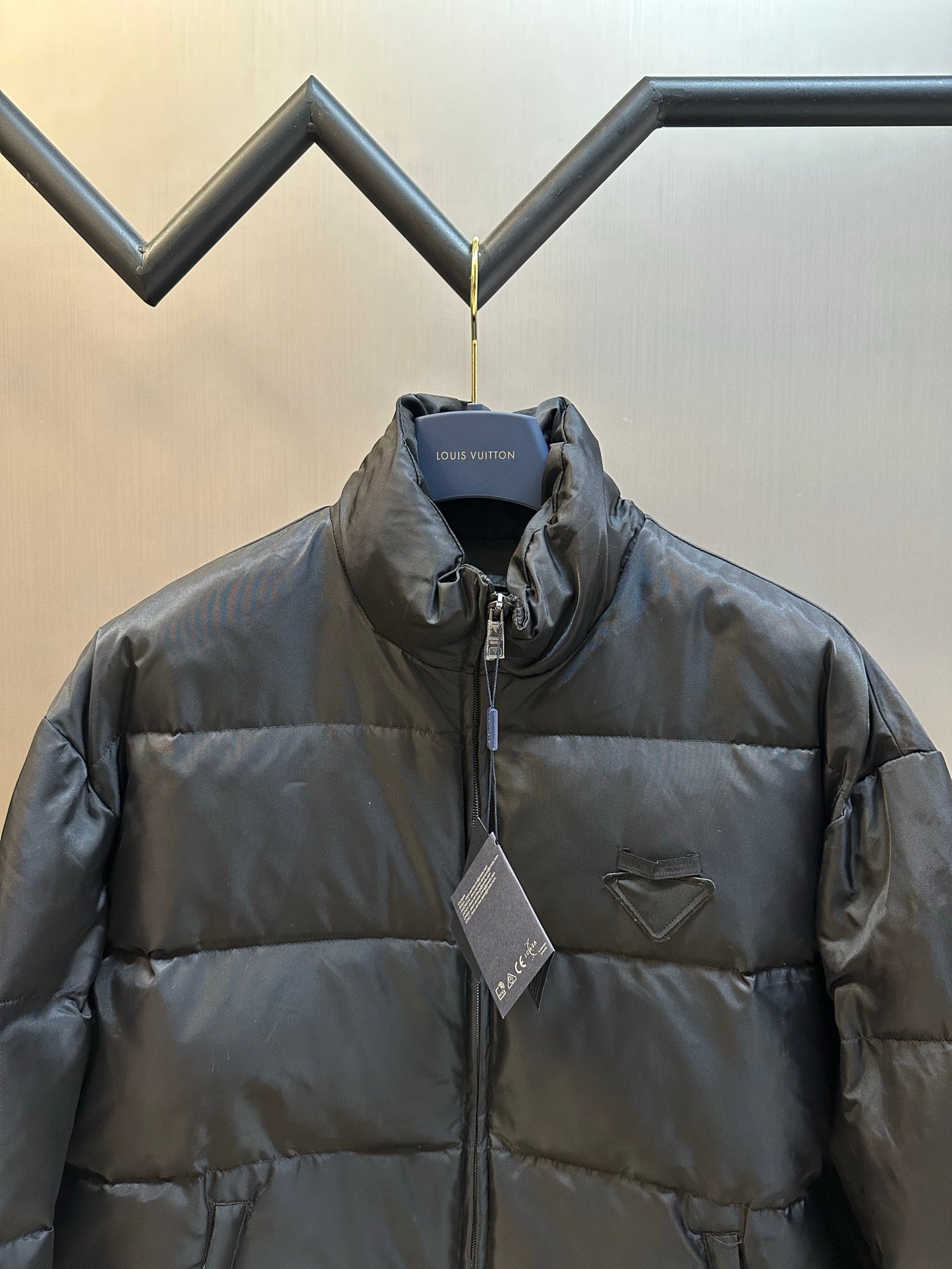 Prada dark puffer jacket front view with chest pocket and zip