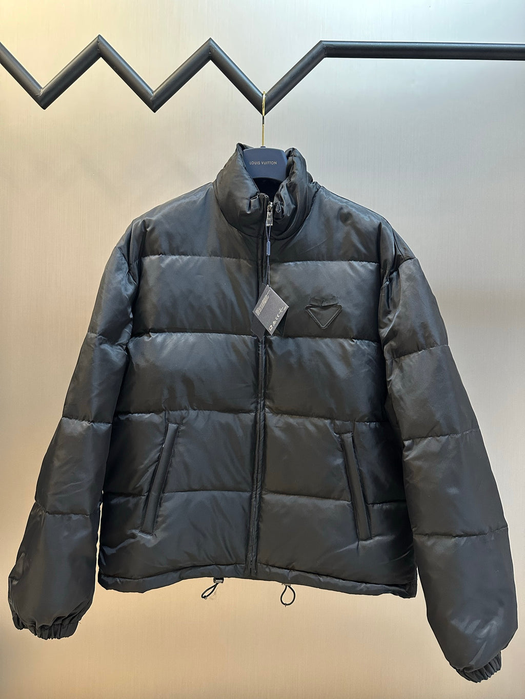 Prada dark puffer jacket with full front zipper and stand collar