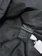 Prada dark puffer jacket interior care label on fabric lining