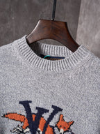 Light gray crewneck knit sweater close-up with ribbed collar and multicolor graphic