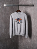 Light gray knit sweater with crew neck and multicolor graphic cartoon logo on chest