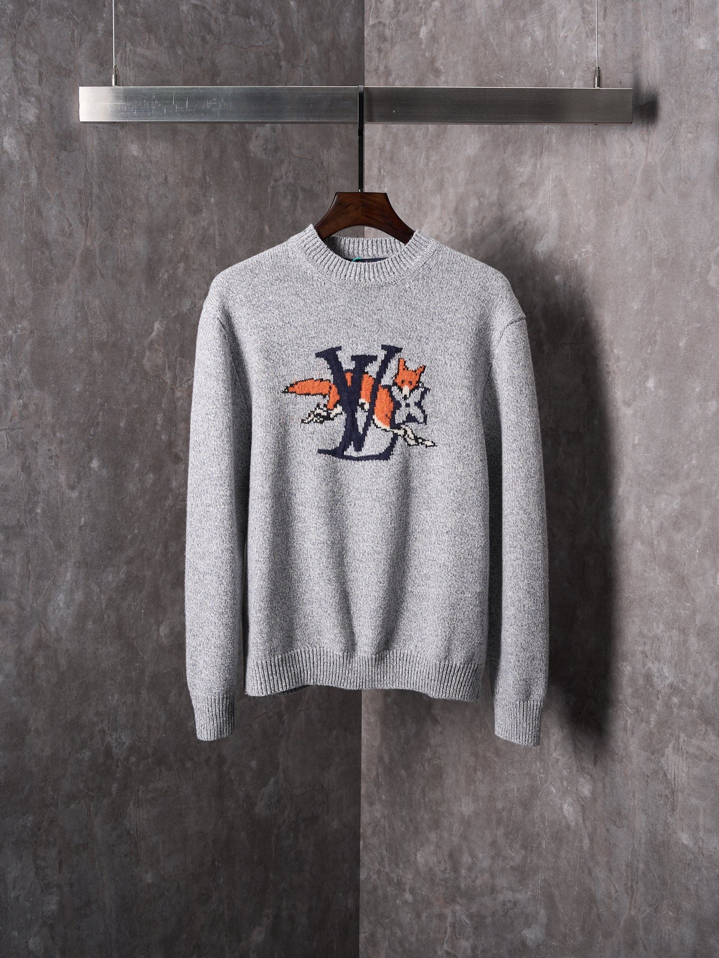 Light gray knit sweater with crew neck and multicolor graphic cartoon logo on chest