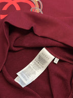 Maroon sweatshirt with inner care label attached inside neckline area
