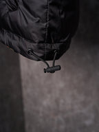 Black long puffer jacket hem with drawstring toggle
