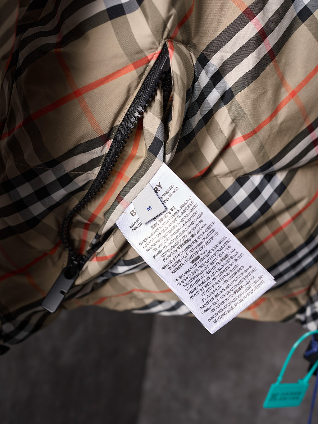Burberry long check coat fabric with attached product label tag