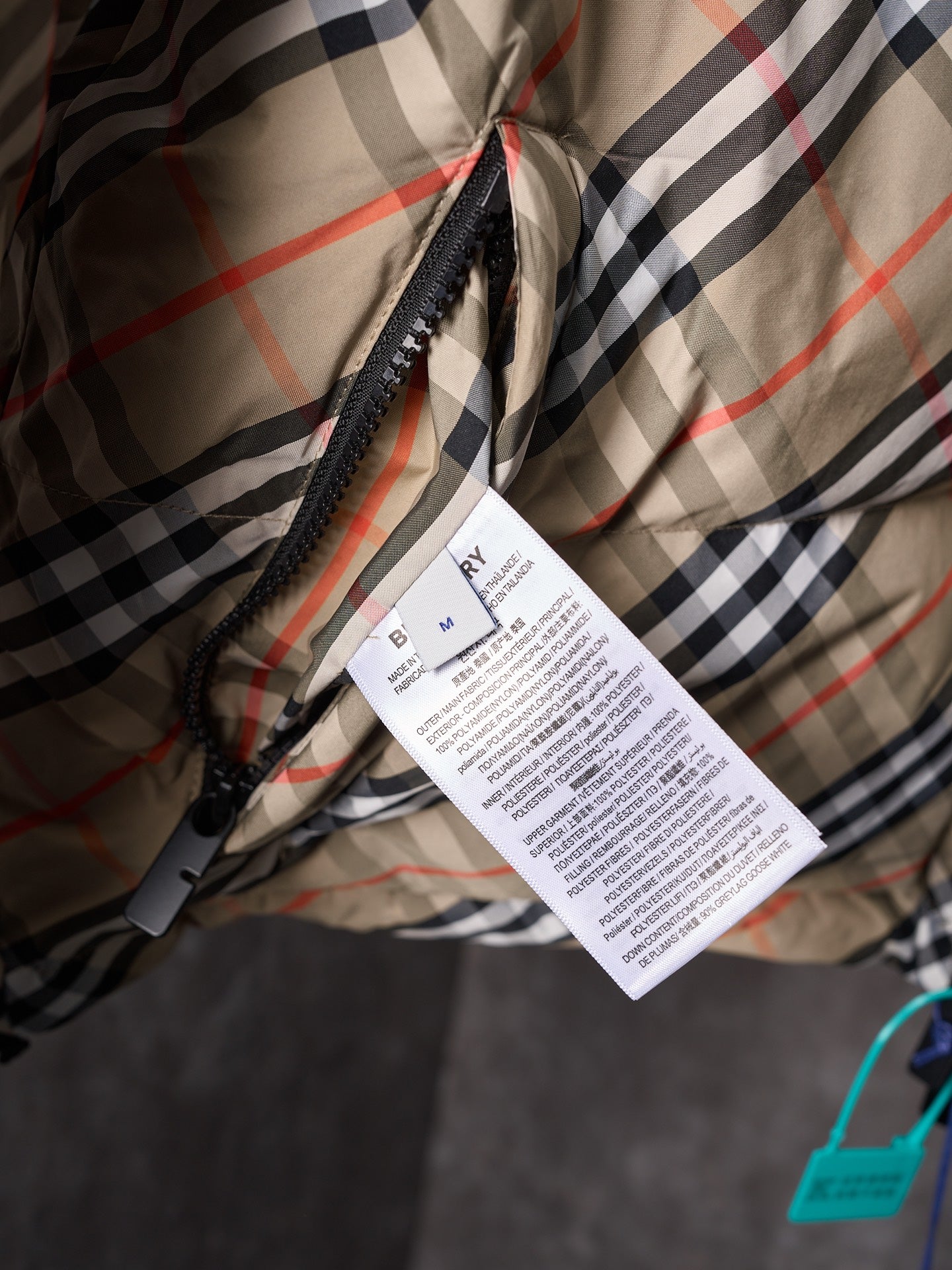 Burberry long check coat fabric with attached product label tag