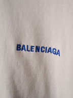 Off-white fabric close-up with blue BALENCIAGA lettering