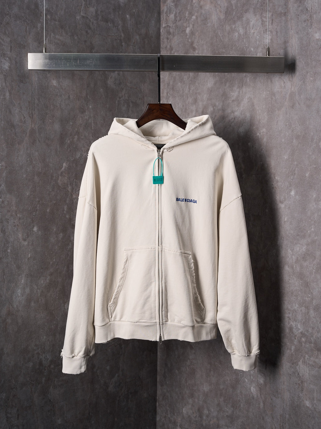 Off-white zip-up hoodie with hood, front pocket and Balenciaga chest logo