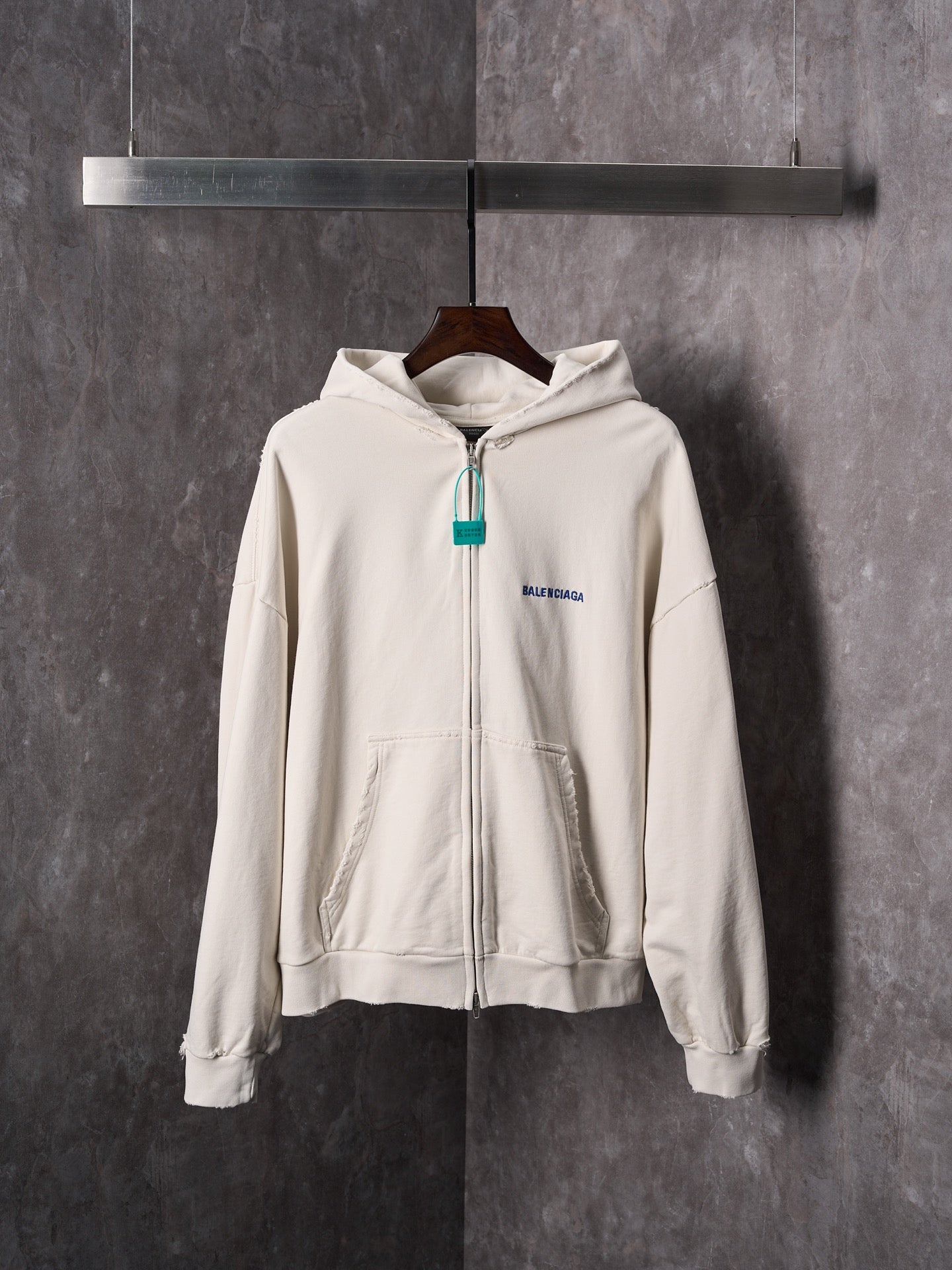 Off-white zip-up hoodie with hood, front pocket and Balenciaga chest logo