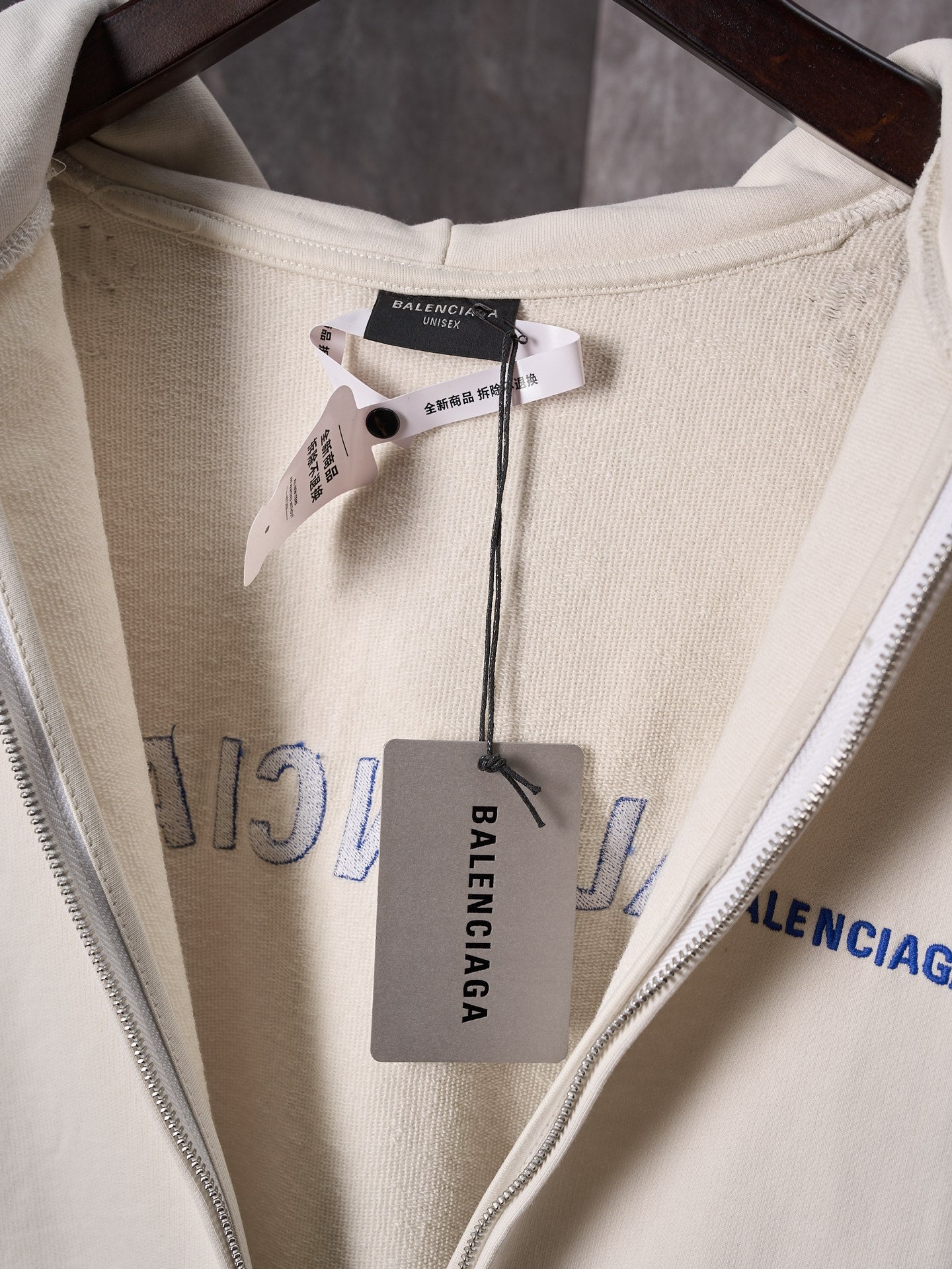 Off-white hoodie neckline with size tag and Balenciaga label inside