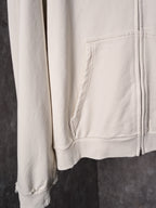 White long-sleeve hoodie with front pocket and ribbed cuffs, distressed hem